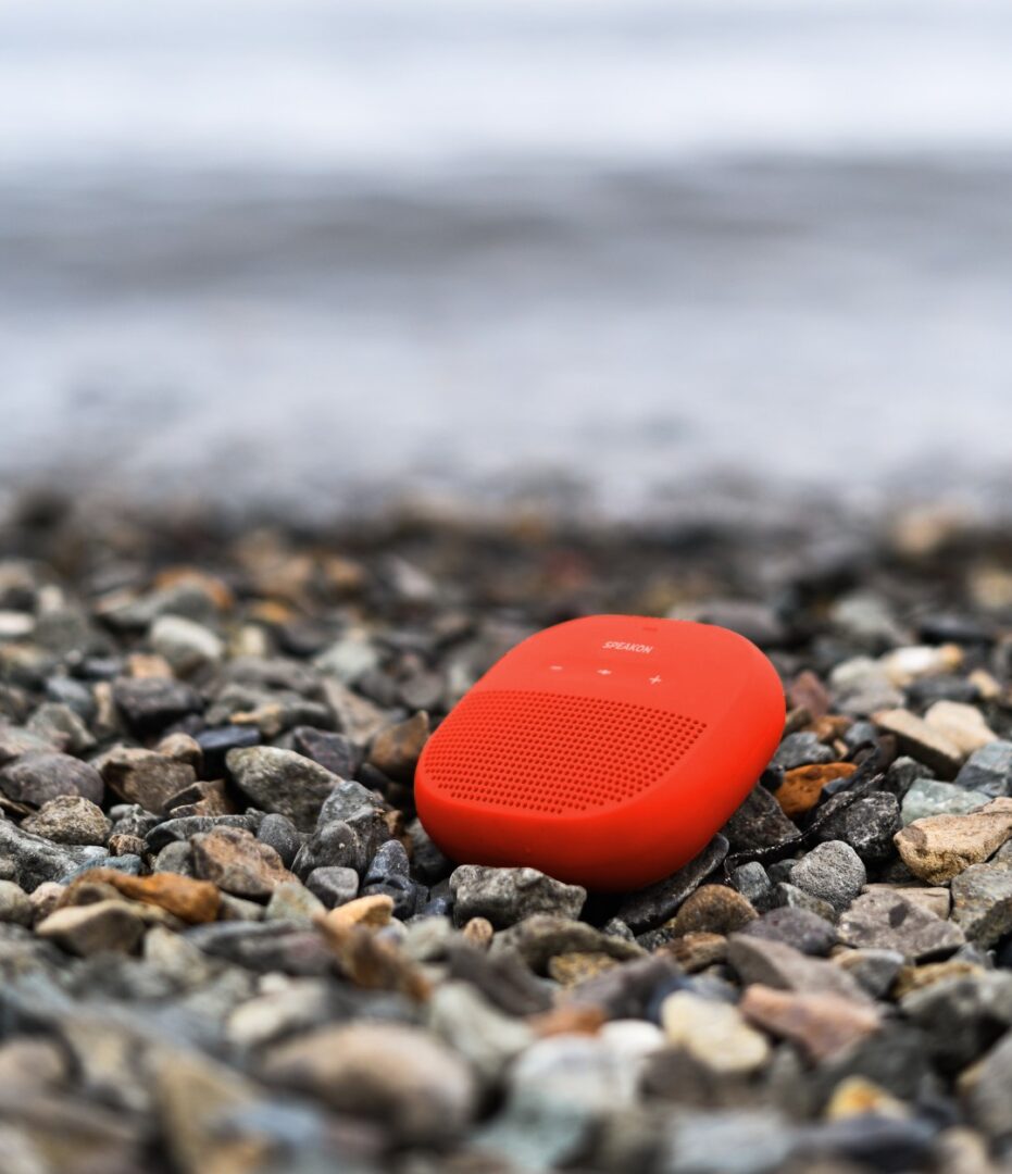 A red object is laying on the ground.